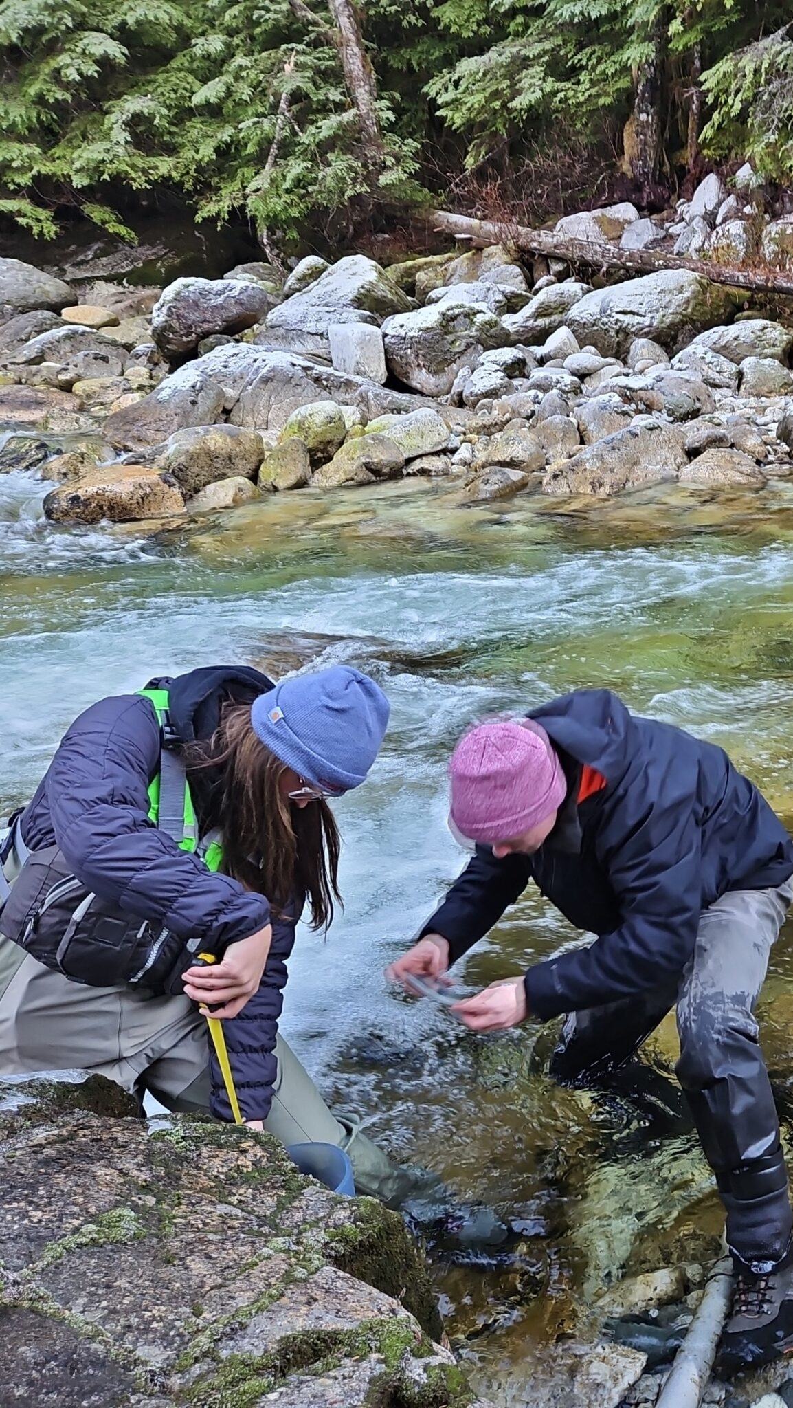 Swiftwater team members collecting field measurements in a creek